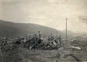 Japanese-American Millworkers standing on wreckage after the PNLC fire. 