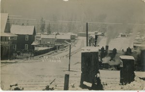 Train running through Eatonville, by the Depot Hotel around 1912