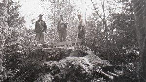 Men on the stump of the old growth tree. 